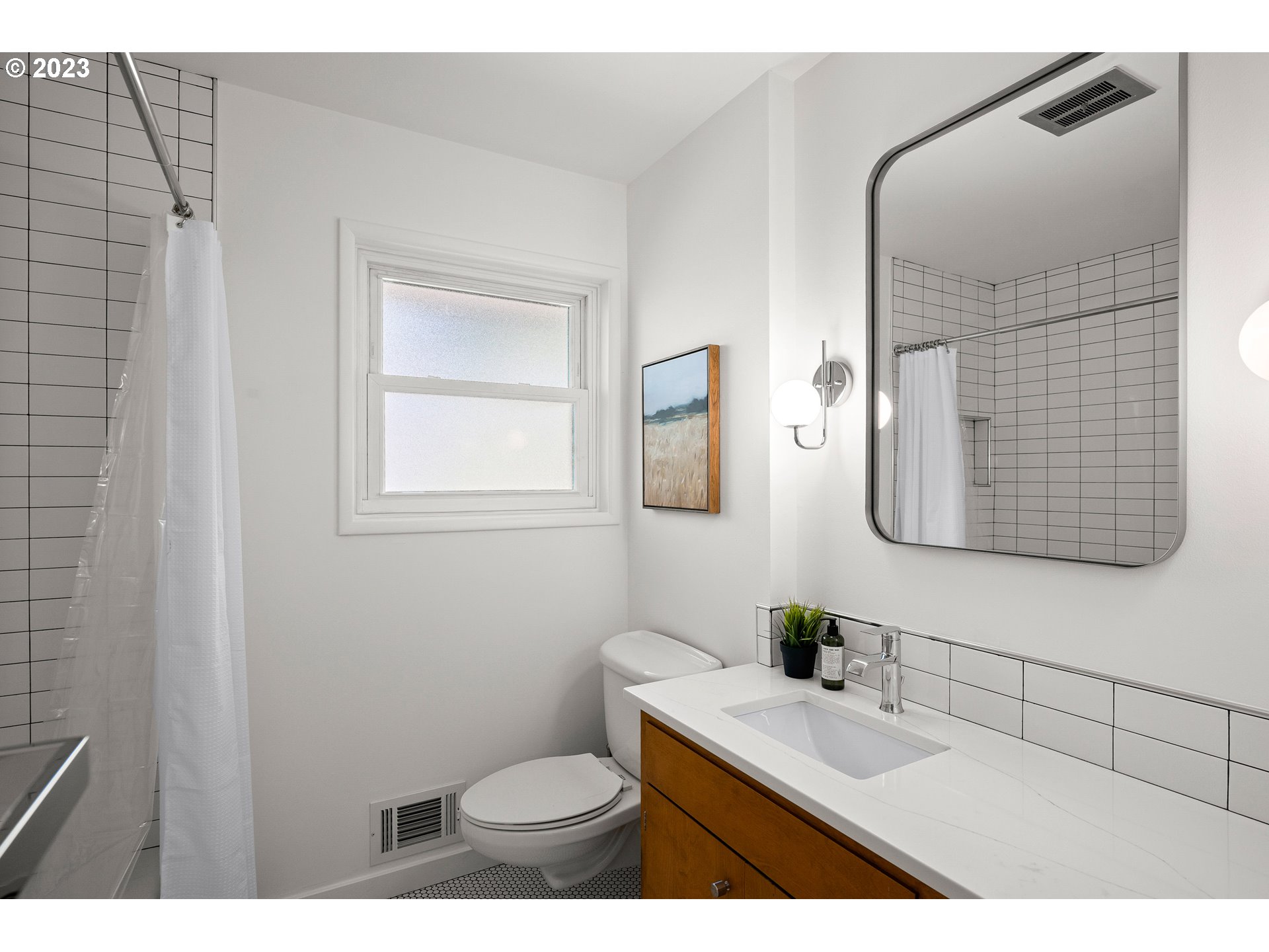 5914 Southwest Gunther Lane Portland, OR 97219 - Photo 18 of 40 a bathroom with a toilet sink and mirror