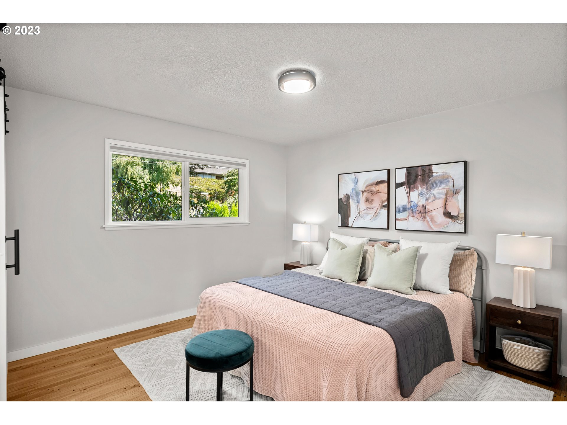 5914 Southwest Gunther Lane Portland, OR 97219 - Photo 19 of 40 a bedroom with a bed and a painting on the wall