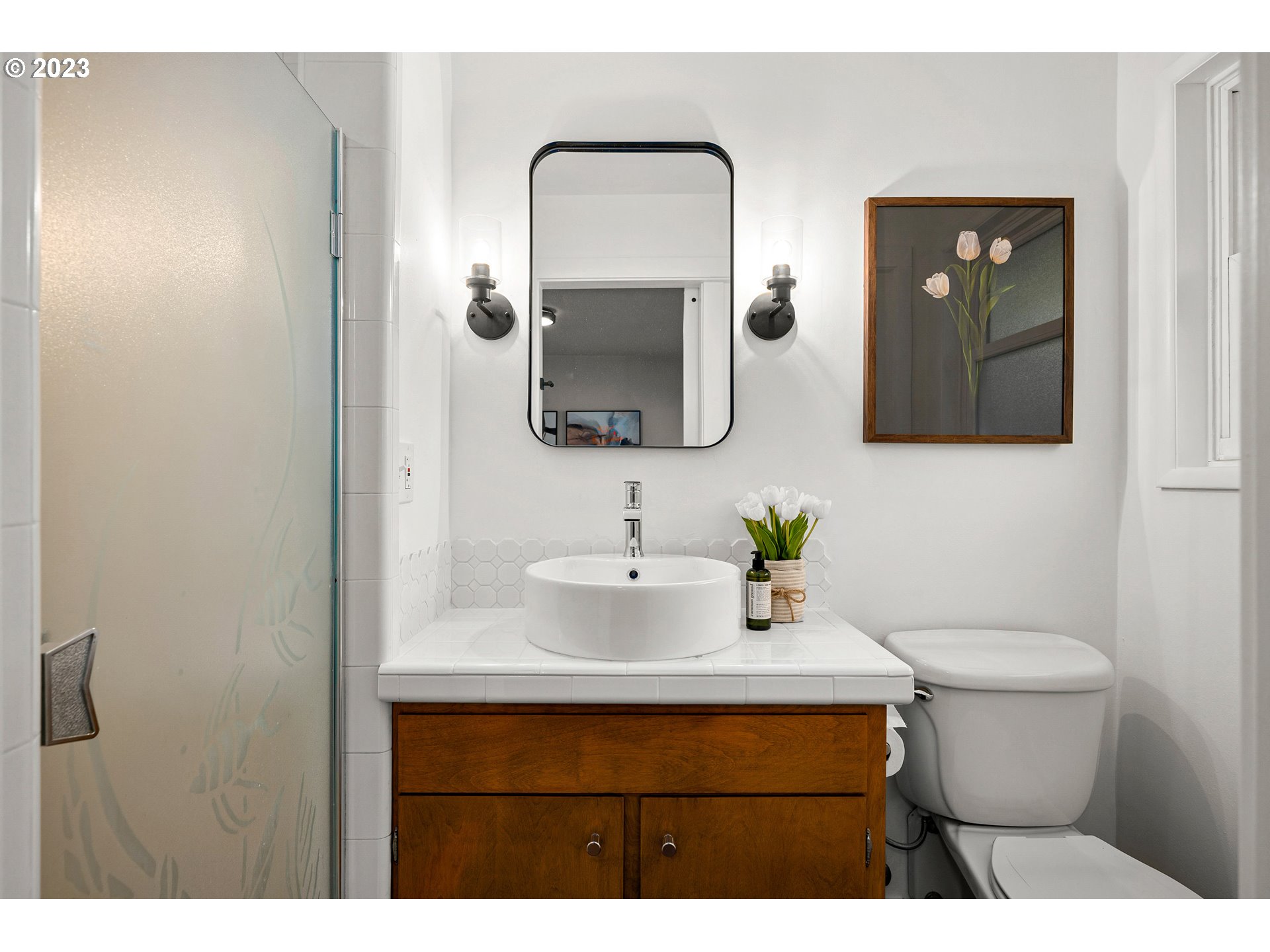 5914 Southwest Gunther Lane Portland, OR 97219 - Photo 20 of 40 a bathroom with a toilet sink and mirror