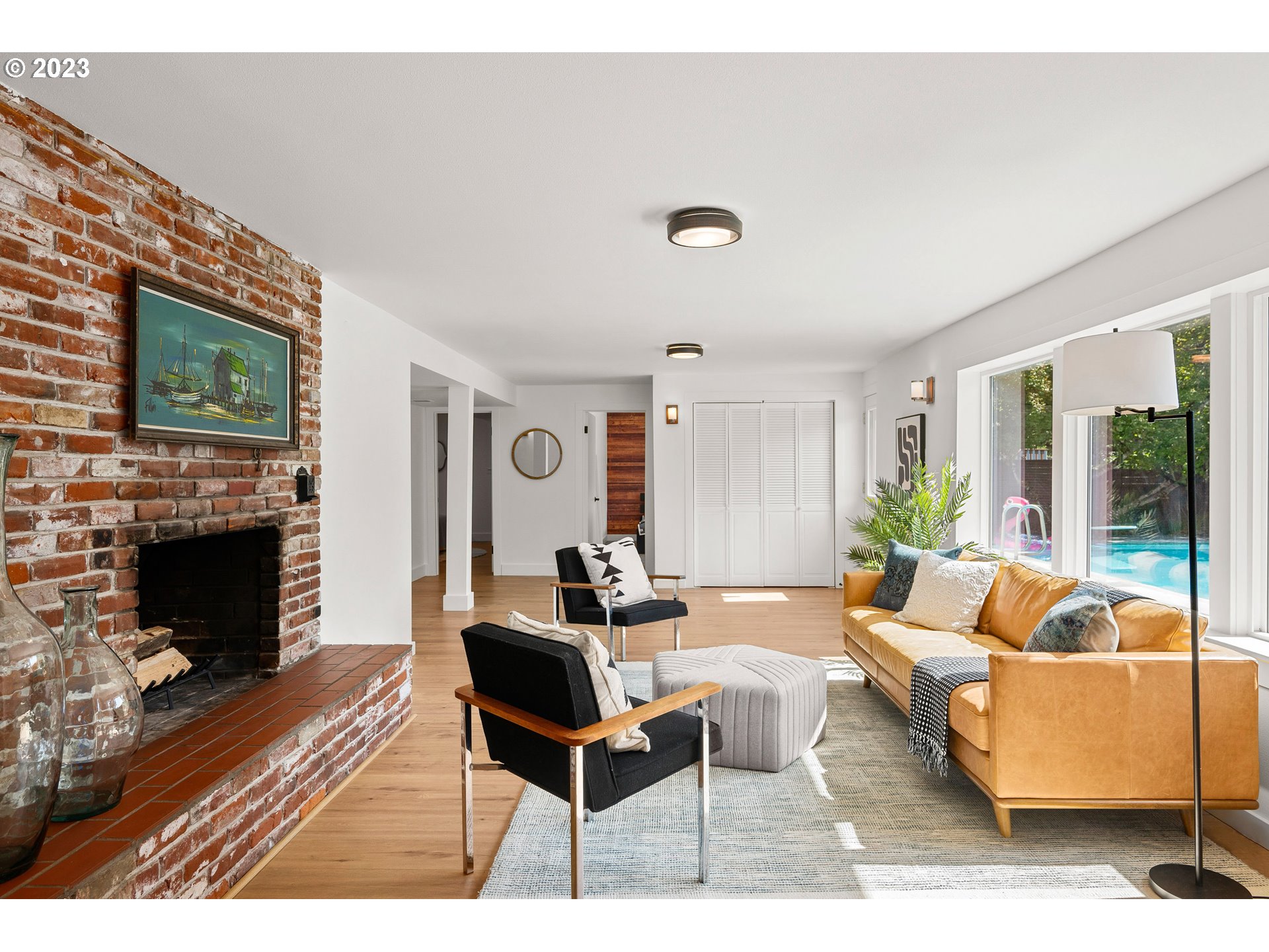 5914 Southwest Gunther Lane Portland, OR 97219 - Photo 21 of 40 a living room with furniture a fireplace and a flat screen tv