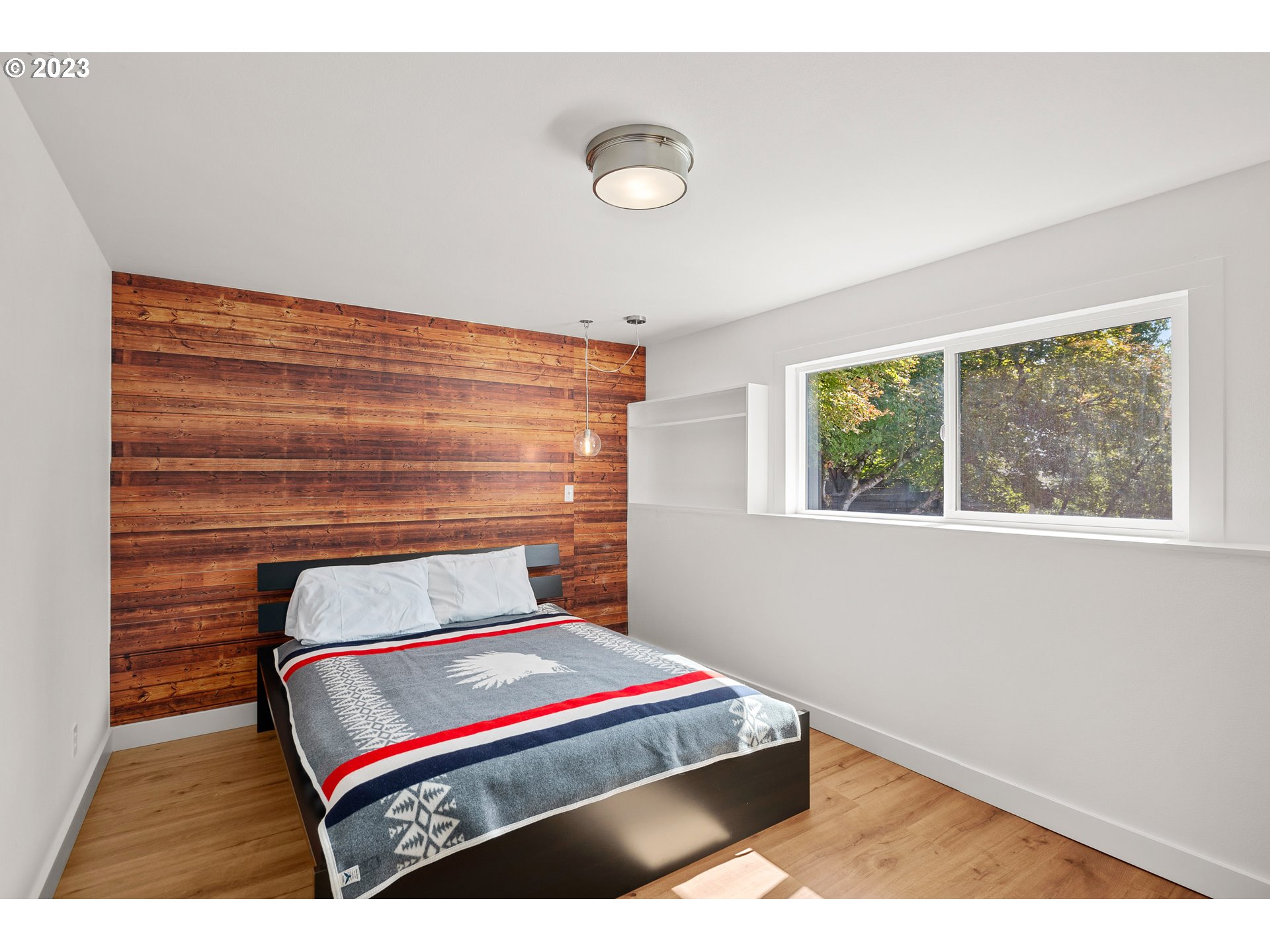 5914 Southwest Gunther Lane Portland, OR 97219 - Photo 28 of 40 a bedroom with a bed and a window