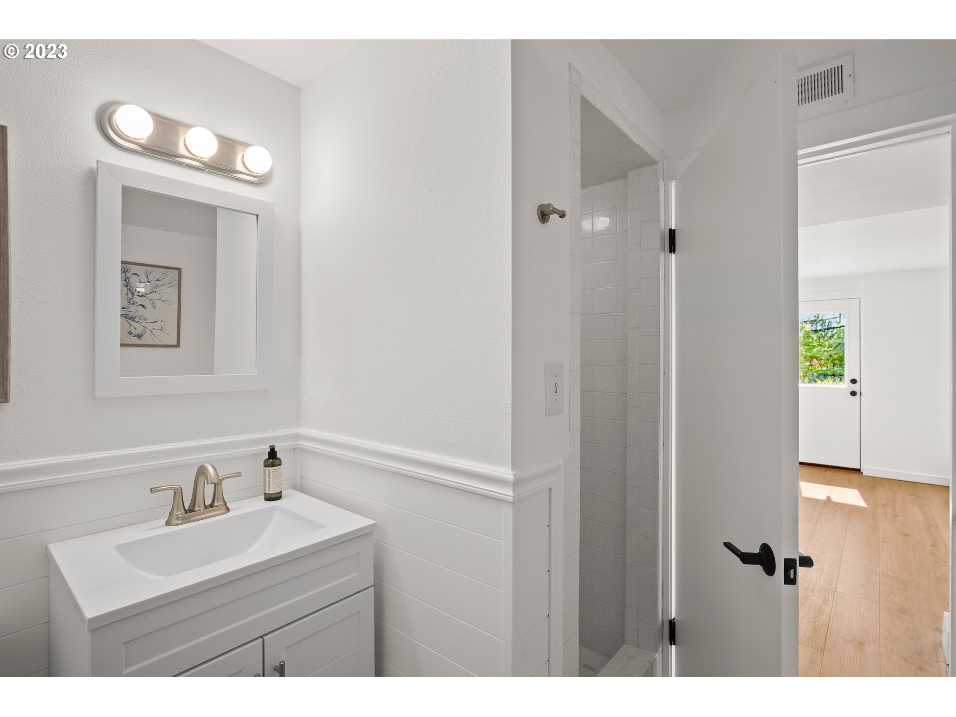 5914 Southwest Gunther Lane Portland, OR 97219 - Photo 30 of 40 a bathroom with a sink a toilet and a mirror