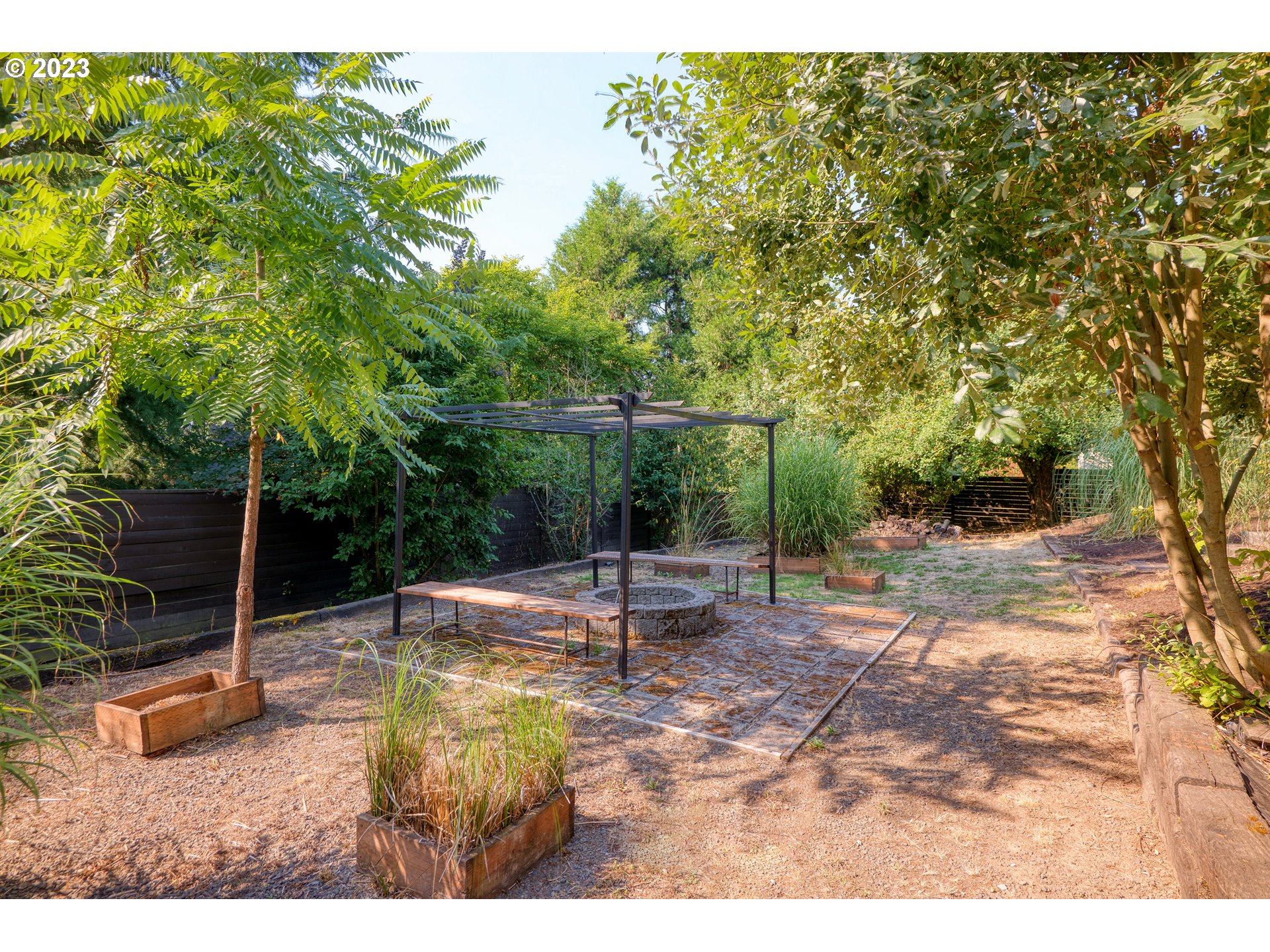 5914 Southwest Gunther Lane Portland, OR 97219 - Photo 37 of 40 a backyard of a house with table and chairs