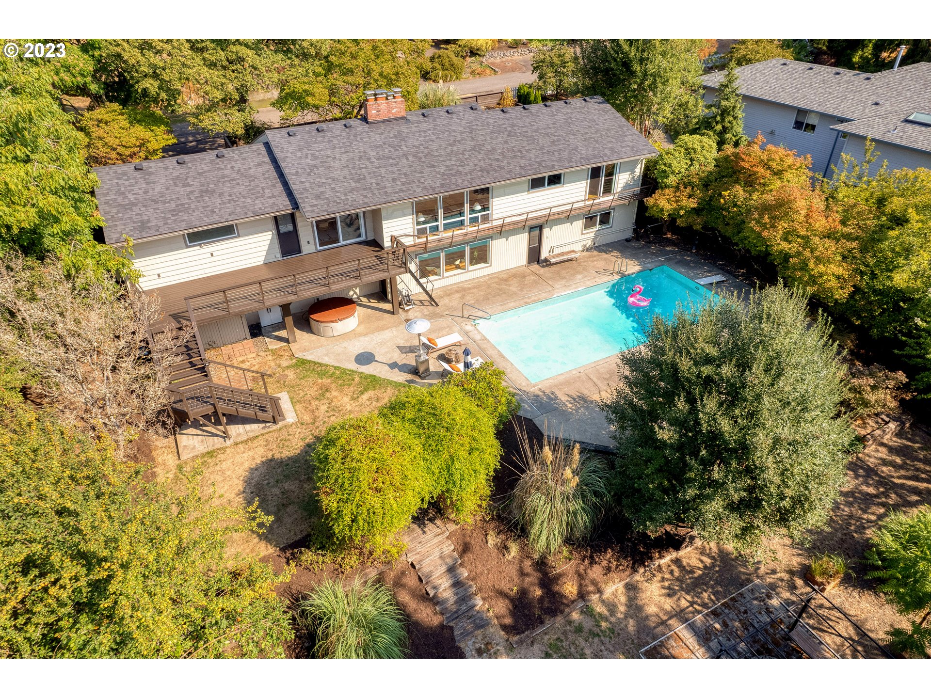 5914 Southwest Gunther Lane Portland, OR 97219 - Photo 38 of 40 a aerial view of a house with table and chairs and potted plants