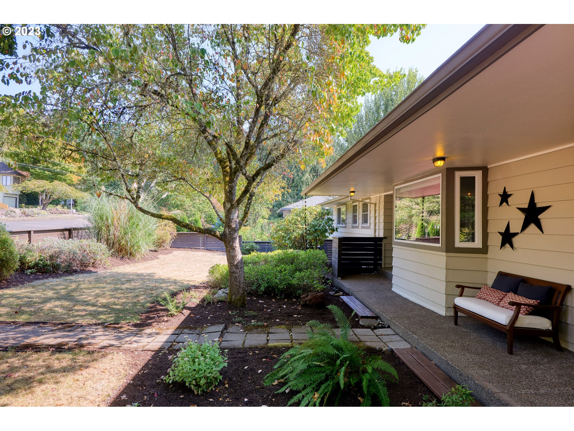 5914 Southwest Gunther Lane Portland, OR 97219 - Photo 4 of 40 a view of backyard with table and chairs and a fire pit