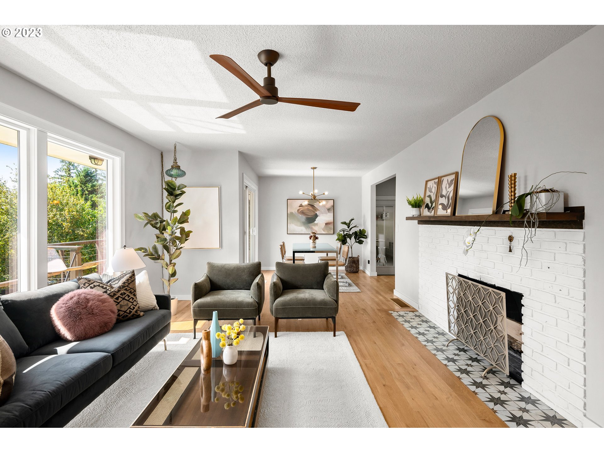 5914 Southwest Gunther Lane Portland, OR 97219 - Photo 7 of 40 a living room with furniture a fireplace and a large window