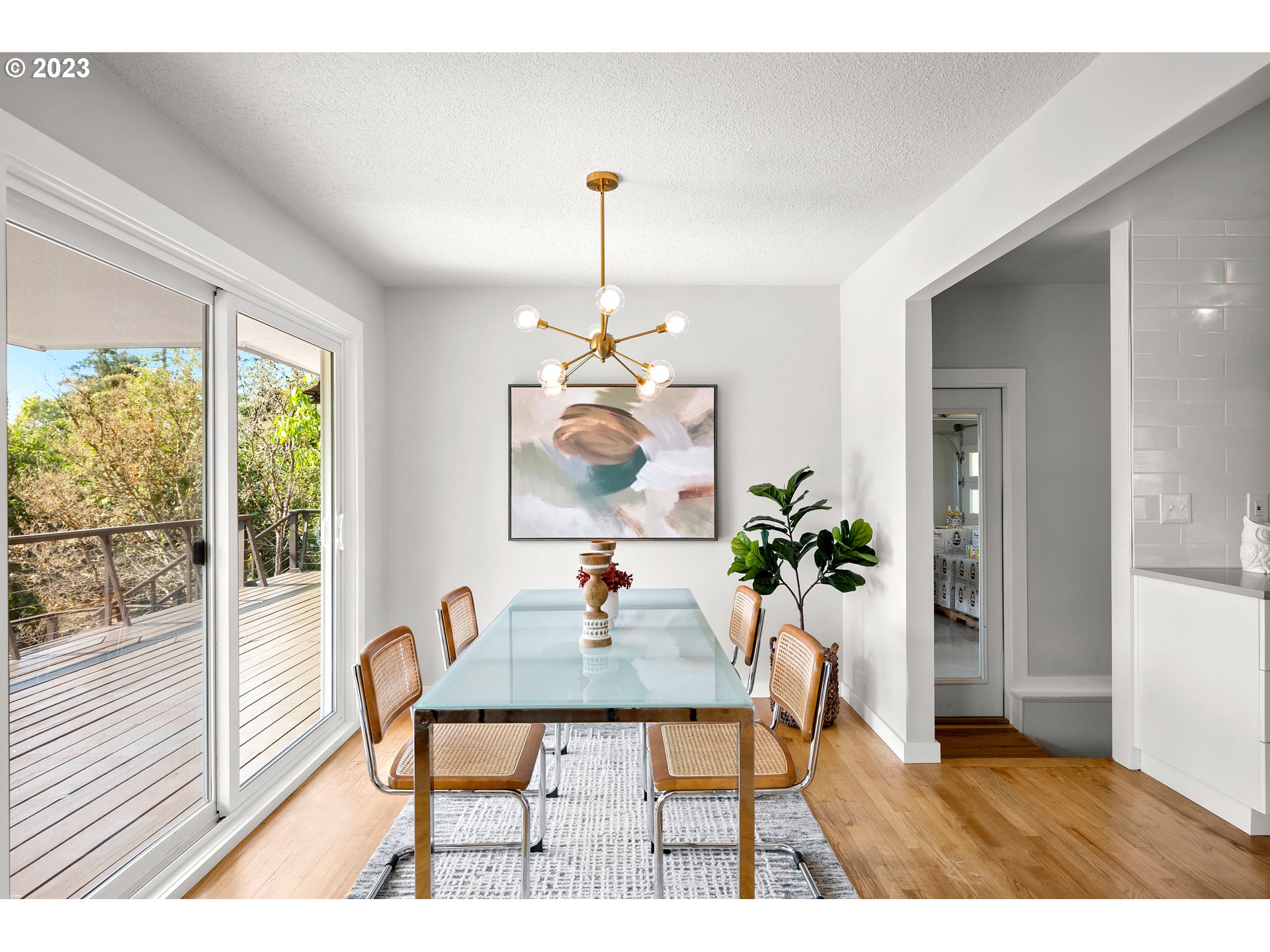 5914 Southwest Gunther Lane Portland, OR 97219 - Photo 8 of 40 a dining room with furniture potted plants and wooden floor
