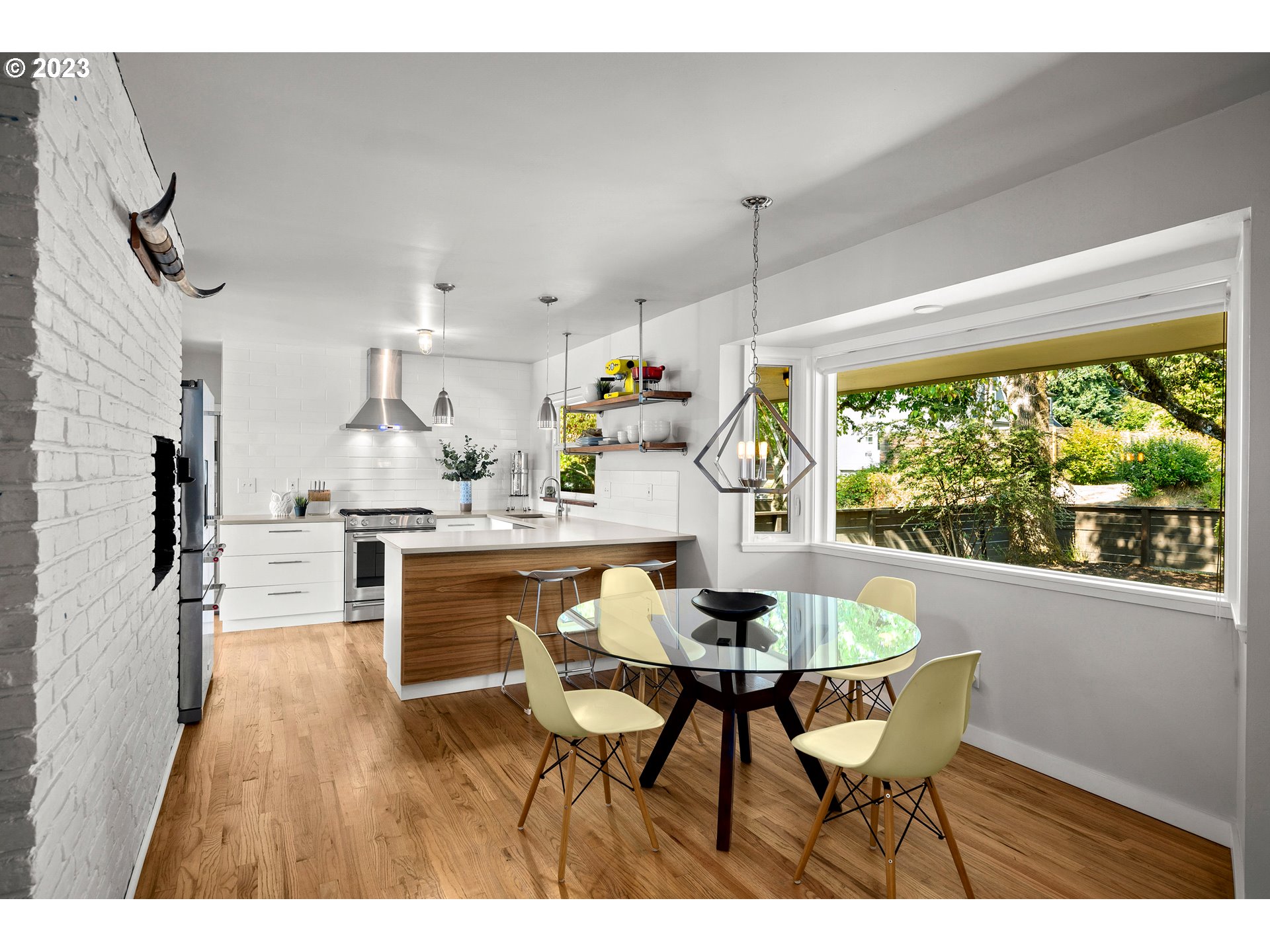 5914 Southwest Gunther Lane Portland, OR 97219 - Photo 10 of 40 a dining room with furniture window wooden floor
