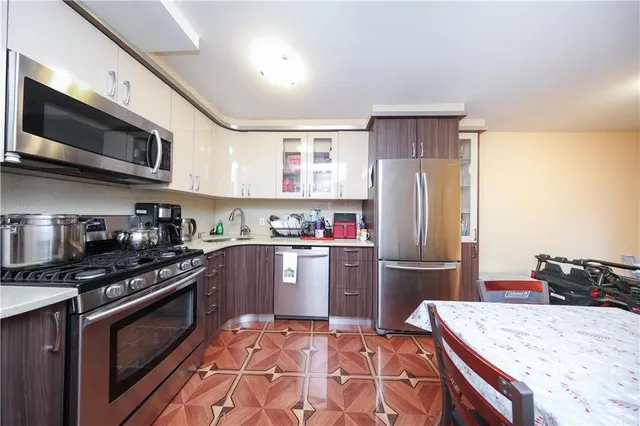 a kitchen with stainless steel appliances granite countertop a refrigerator stove and sink