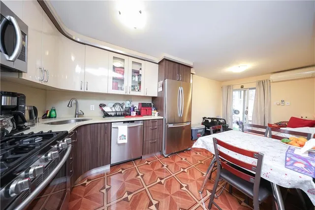a kitchen with a refrigerator and a stove