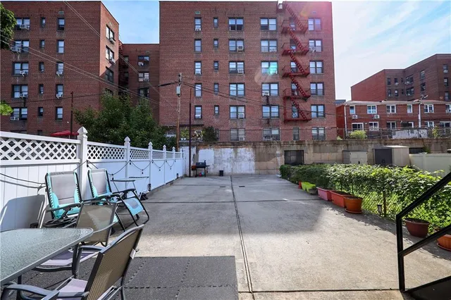 a view of a patio with couches table and chairs and potted plants