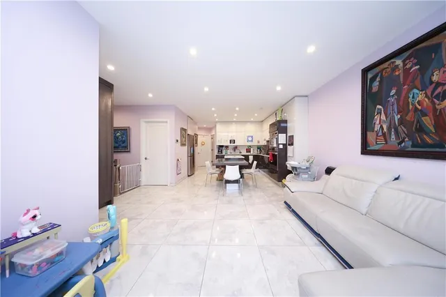 a living room with furniture and kitchen view