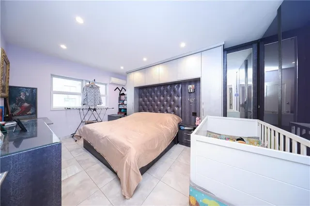 a bed room with a bed and a flat screen tv