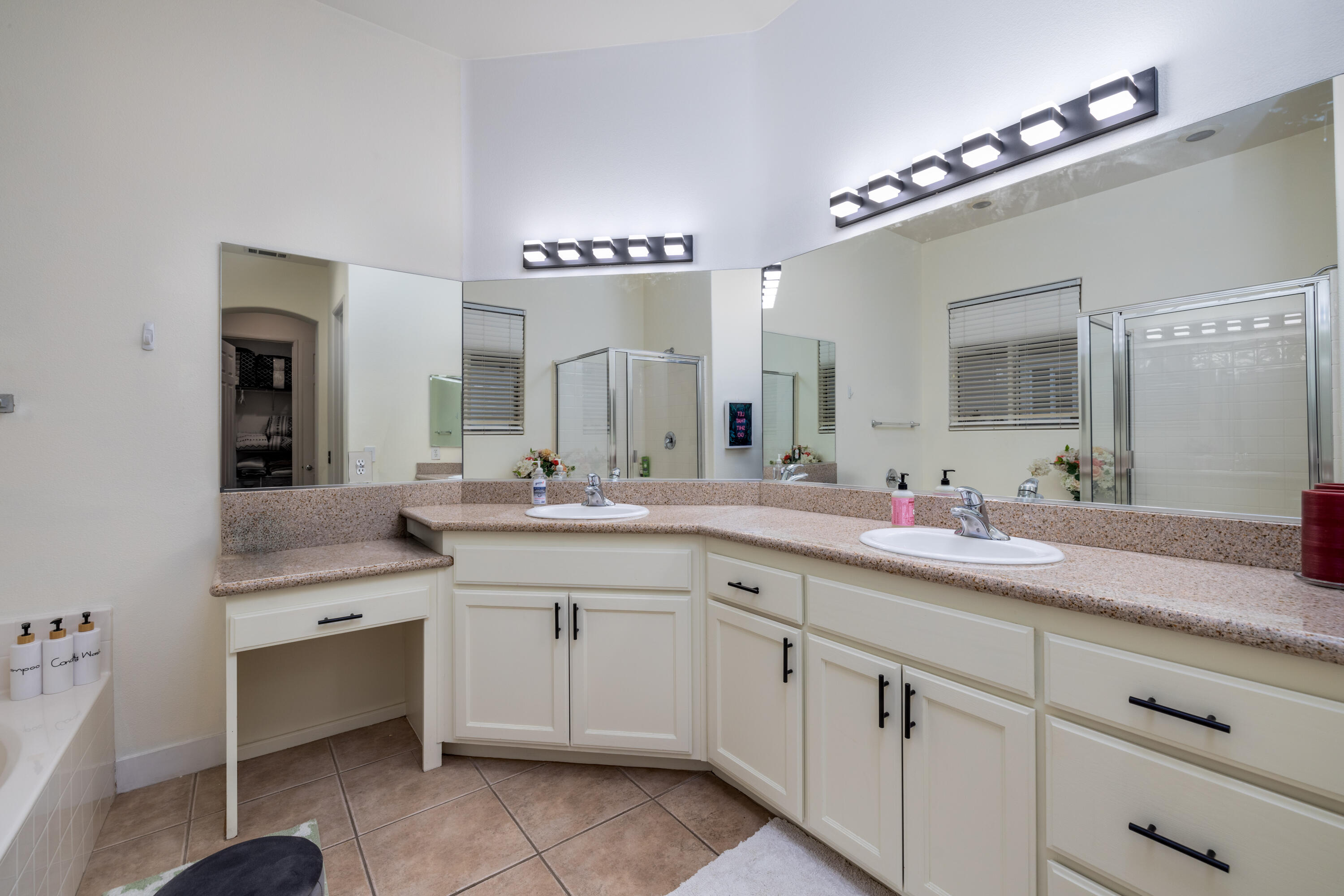 49527 Wayne Street Indio, CA 92201 - Photo 24 of 147 a spacious bathroom with a sink a mirror and a bathtub