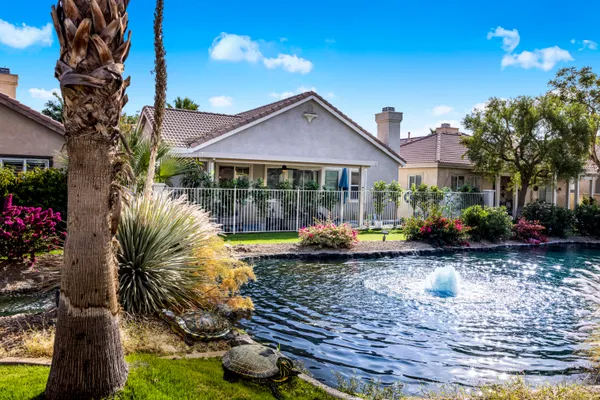 a view of swimming pool with a lounge chairs