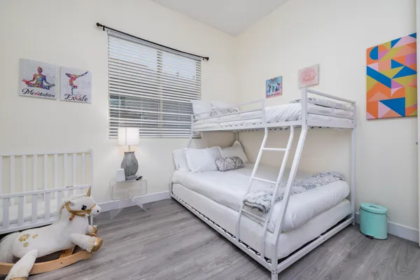 a front view of a house with a yard and potted plants