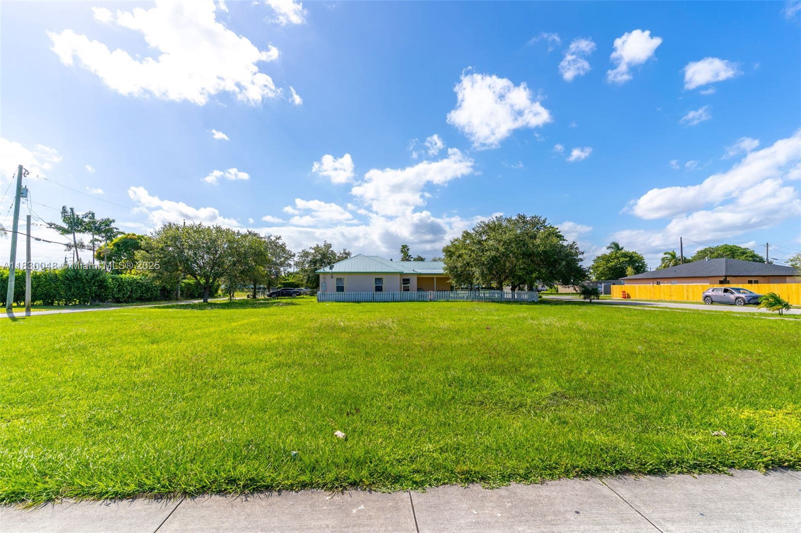 604 Southwest 6th Avenue Homestead, FL 33030 - Photo 9 of 18 a view of a big yard with swimming pool and green space