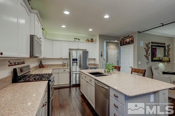 10520 Baton Court Reno, NV 89521 - Photo 5 of 38 a kitchen with a sink a counter top space stainless steel appliances and cabinets