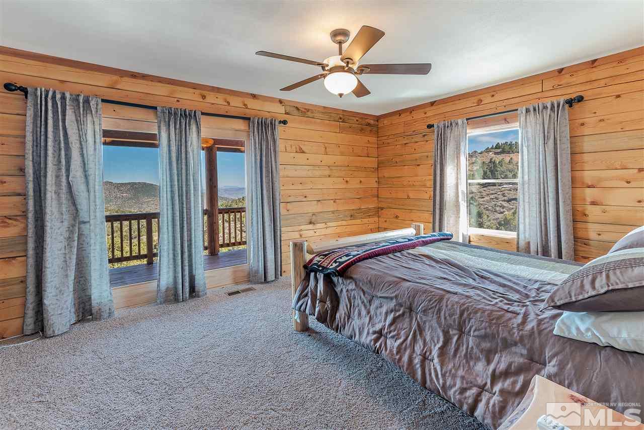 4820 Livery Road Reno, NV 89521 - Photo 12 of 25 a bed sitting in a spacious bedroom next to a window