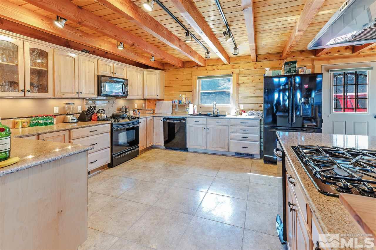 4820 Livery Road Reno, NV 89521 - Photo 8 of 25 a kitchen with cabinets wooden floor and stainless steel appliances