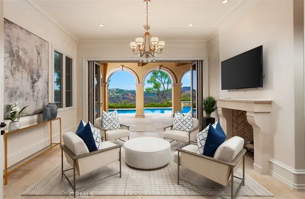 a living room with fireplace furniture and a large window