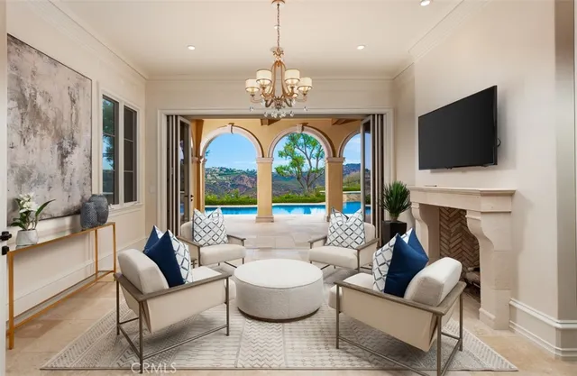 a living room with fireplace furniture and a large window