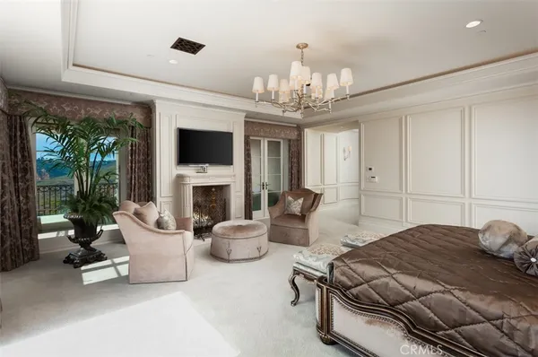 a bedroom with a bed and a chandelier