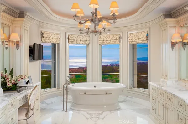 a view of spacious bathroom with a tub and shower