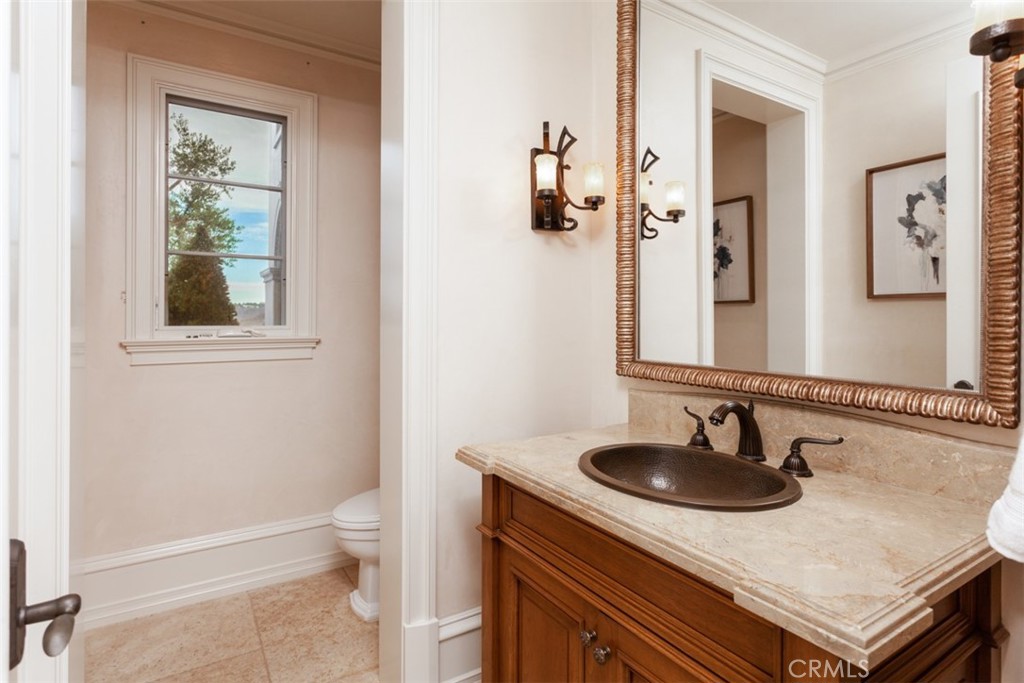 1 Shell Beach Newport Coast, CA 92657 - Photo 26 of 46 a bathroom with a sink toilet a mirror and vanity