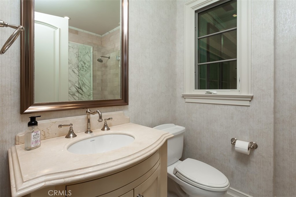 1 Shell Beach Newport Coast, CA 92657 - Photo 28 of 46 a bathroom with a sink a toilet and a mirror