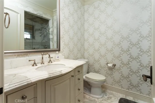 a bedroom with a bed and large windows