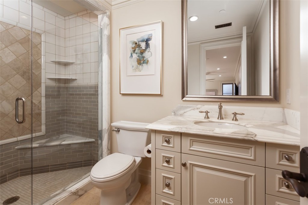 1 Shell Beach Newport Coast, CA 92657 - Photo 32 of 46 a bathroom with a granite countertop toilet sink and shower