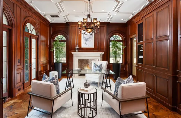a living room with fireplace furniture and a chandelier