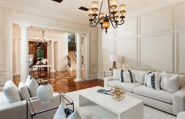 a living room with furniture and chandelier