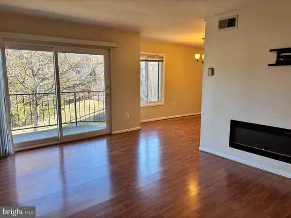 a view of room with window and wooden floor