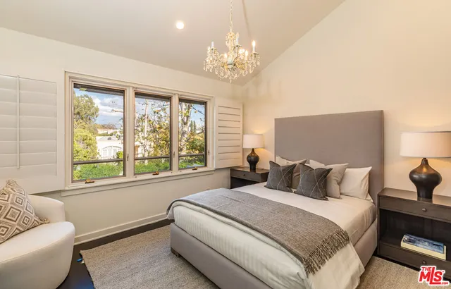 a bedroom with a bed and a potted plant