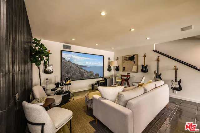 a view of a backyard with barbeque grill and outdoor seating