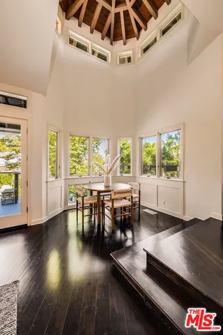 a kitchen with stainless steel appliances granite countertop a dining table chairs and granite counter tops