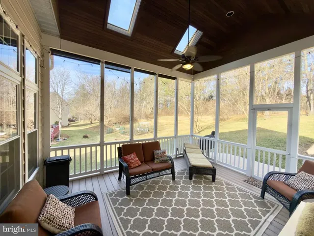 a living room with furniture and large window