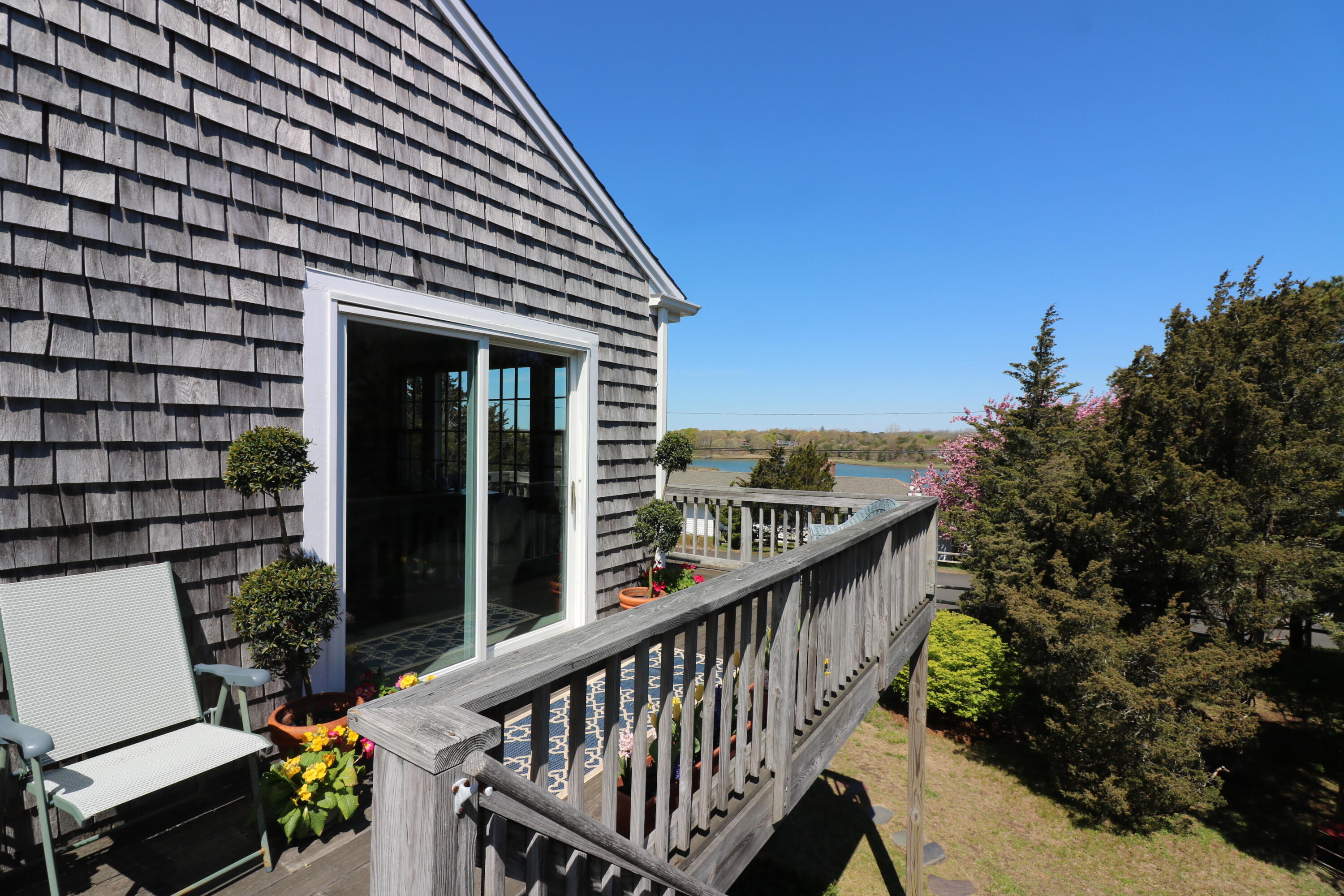 22 Ruggles Road Orleans, MA 02653 - Photo 7 of 38 a balcony with wooden floor and outdoor seating