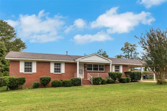a front view of a house with a garden