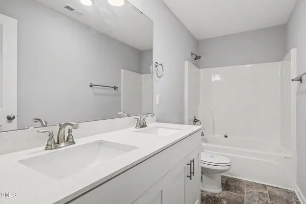 a bathroom with a sink toilet vanity and shower