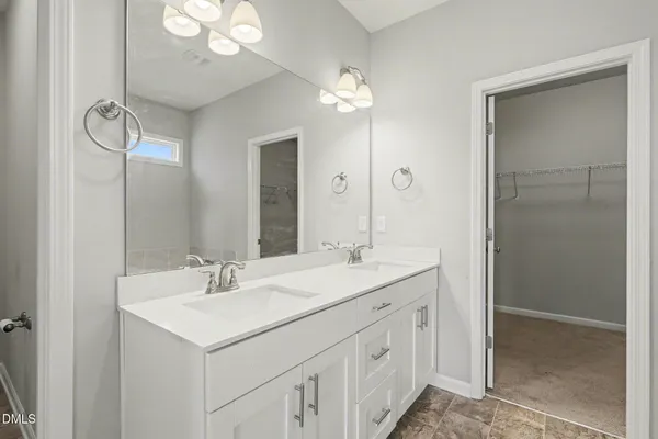a bathroom with a sink double vanity and a mirror
