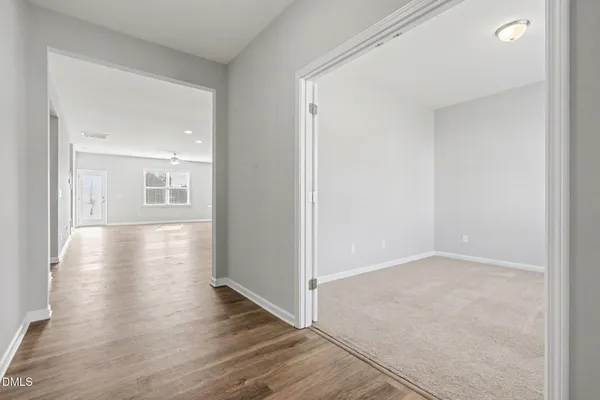 a view of a hallway with wooden floor