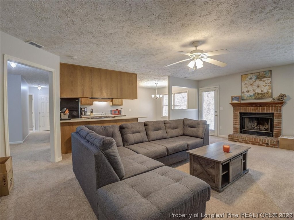 433 Wapiti Drive Spring Lake, NC 28390 - Photo 11 of 31 a living room with furniture a fireplace and a flat screen tv