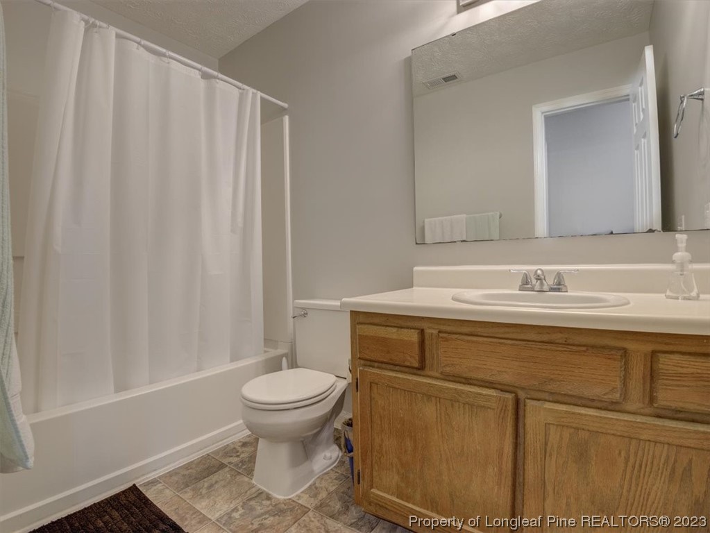 433 Wapiti Drive Spring Lake, NC 28390 - Photo 18 of 31 a bathroom with a sink a toilet and a mirror