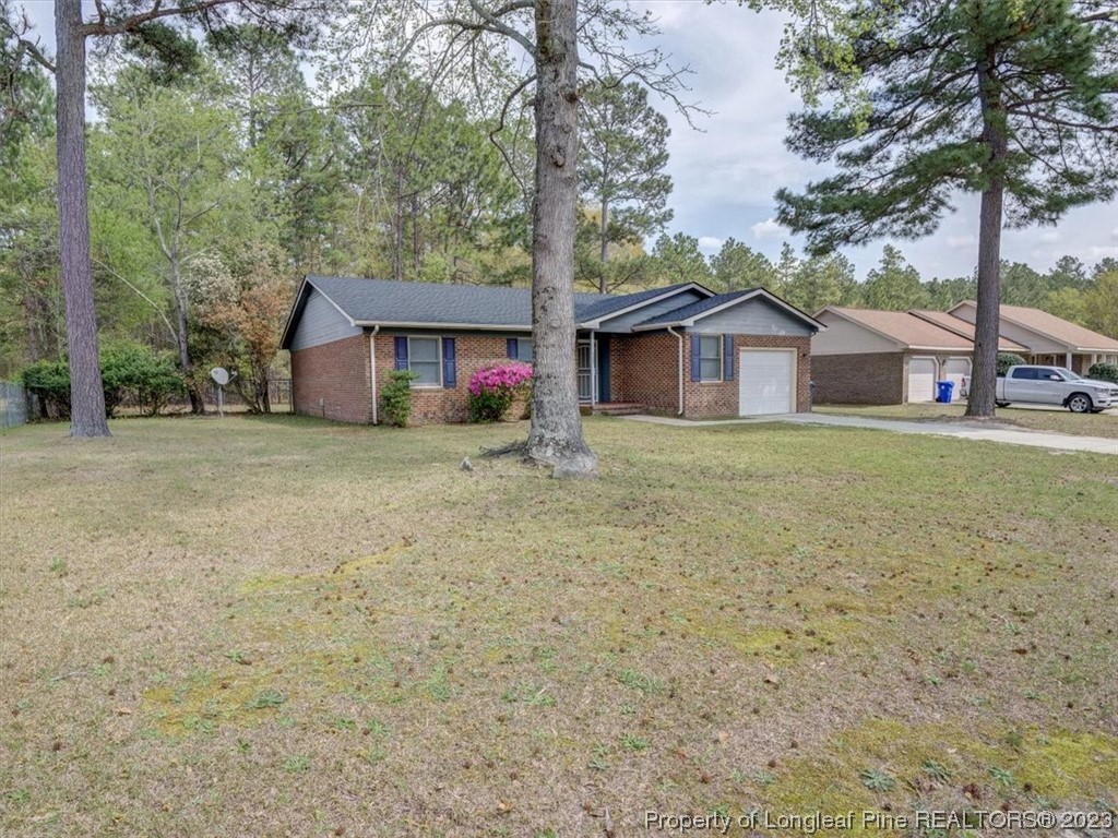 433 Wapiti Drive Spring Lake, NC 28390 - Photo 2 of 31 a white house that has a tree in front of it