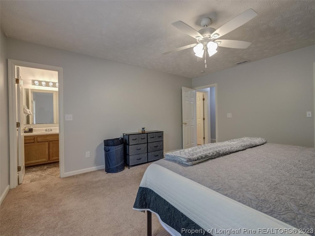 433 Wapiti Drive Spring Lake, NC 28390 - Photo 22 of 31 a bedroom with a bed and a chandelier