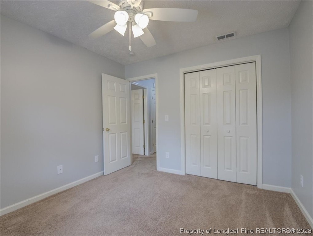 433 Wapiti Drive Spring Lake, NC 28390 - Photo 26 of 31 an empty room with a ceiling fan and a bathroom