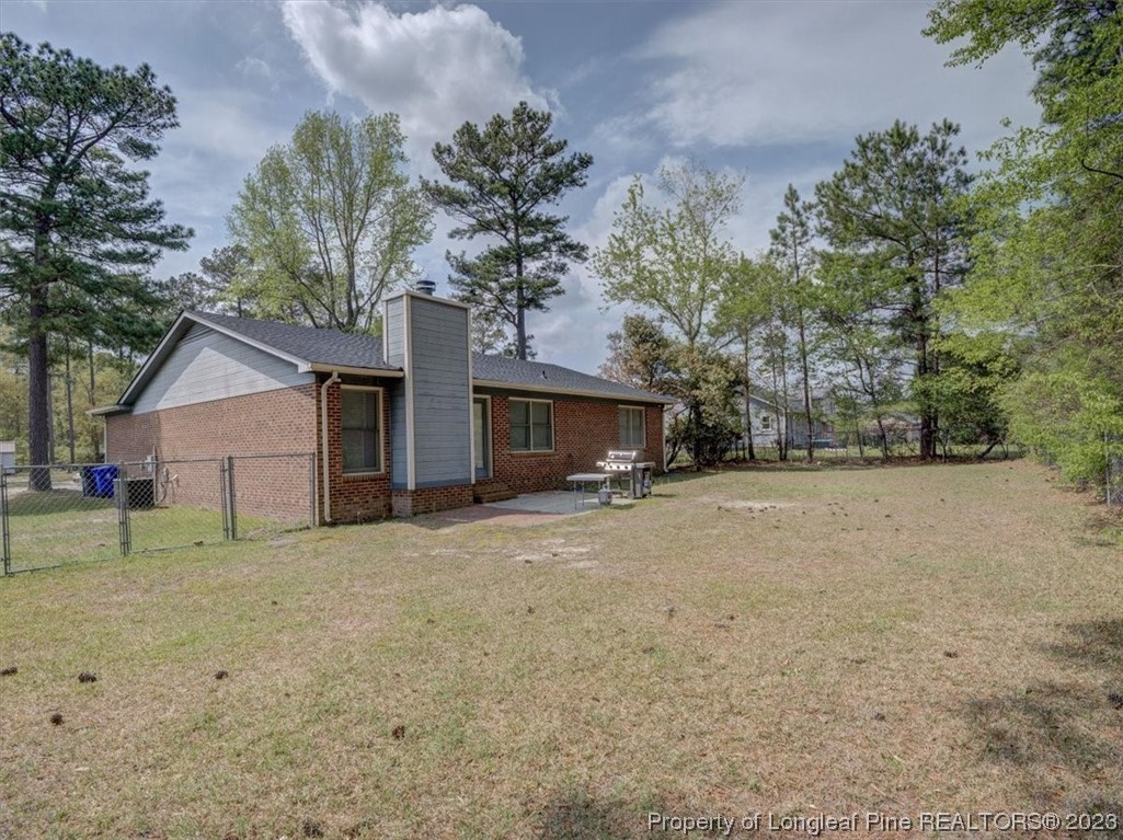 433 Wapiti Drive Spring Lake, NC 28390 - Photo 28 of 31 a view of a house with a yard and tree